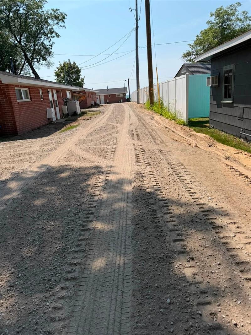 Lane regraded smooth after underground utility work