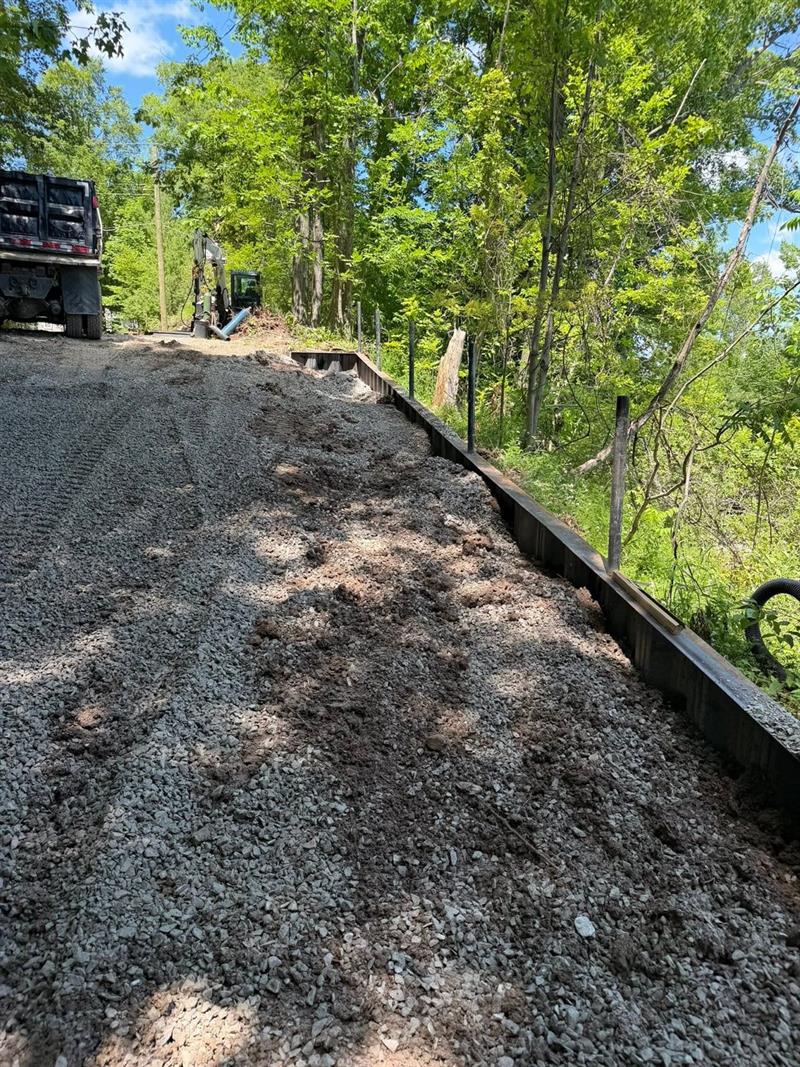 Crushed stone backfill placed against a new steel wall
