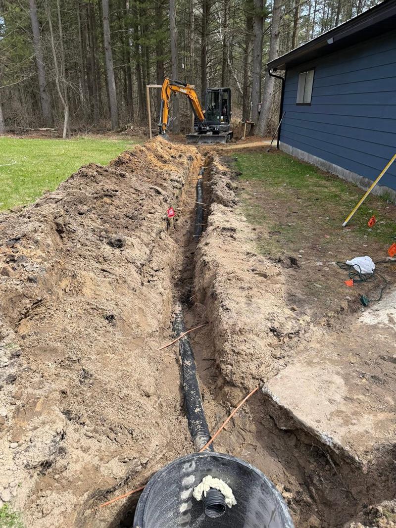 Sewer line trench with new pipe running to the septic tank
